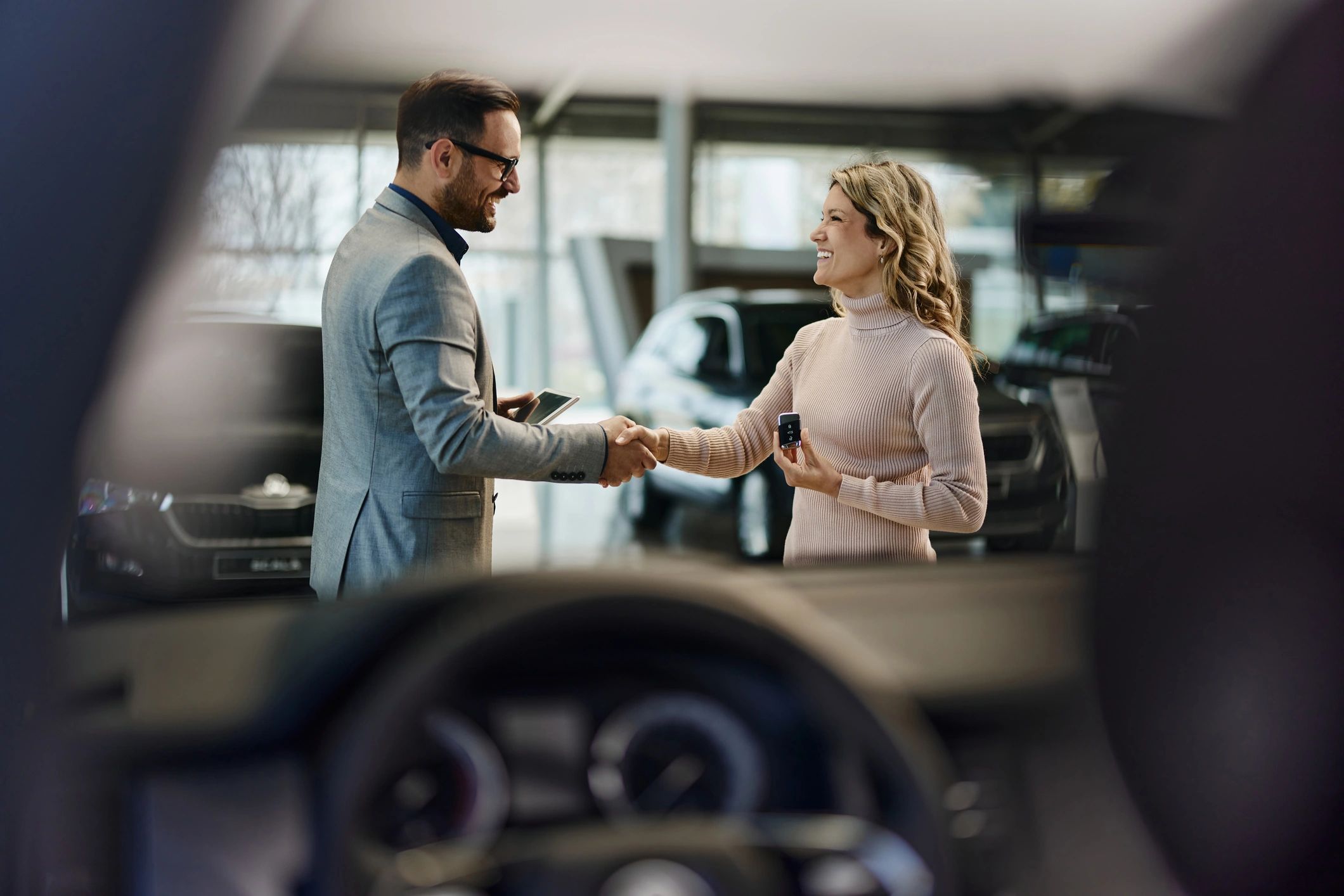 Sales professional congratulating a customer in a showroom