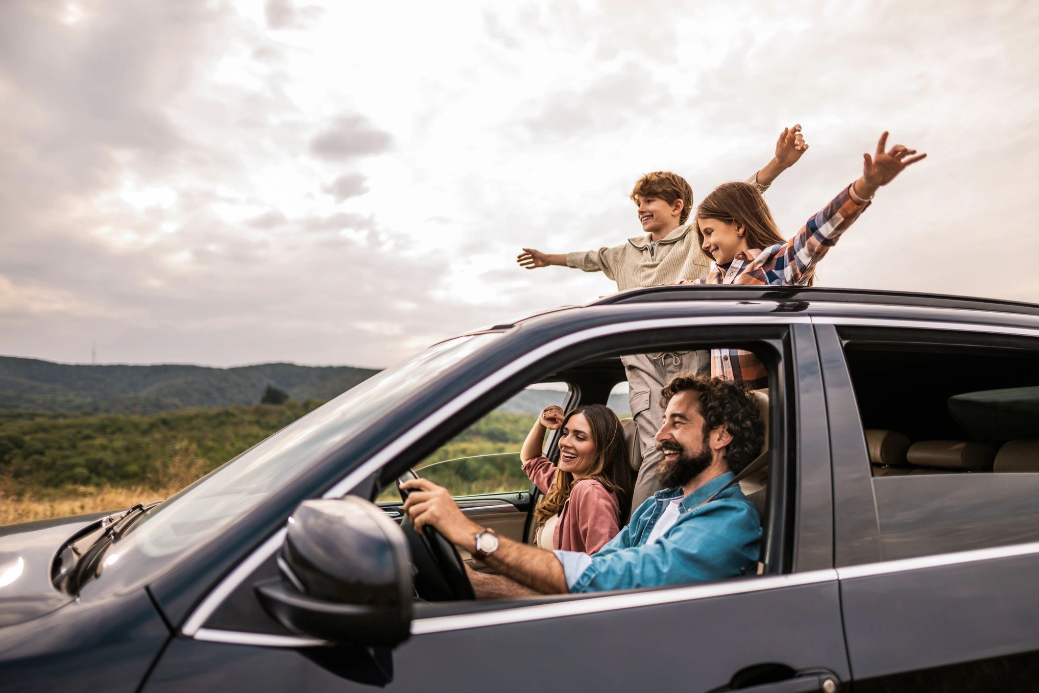 Happy family enjoying a car trip